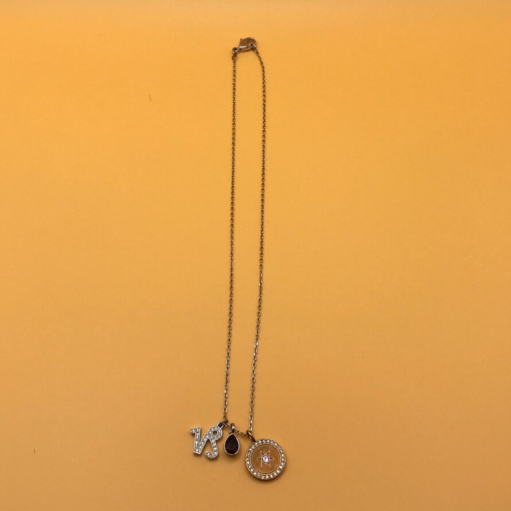 Swarovski Gold-Tone Crystal Circle Necklace with Capricorn Charms